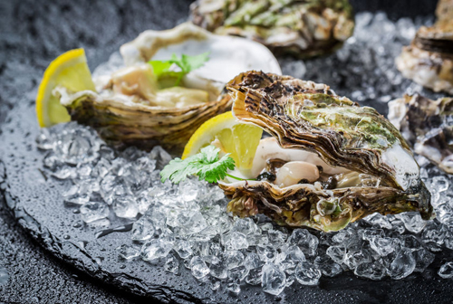 Oysters with lemon on plate